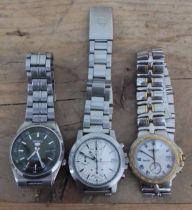 A group of three wristwatches comprising a Seiko 5, a Pulsar and a Raymond Weil.