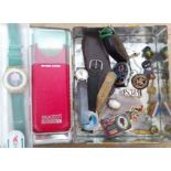 A tin of assorted items including a Swatch watch, Robertsons badges, an antique shell cameo brooch