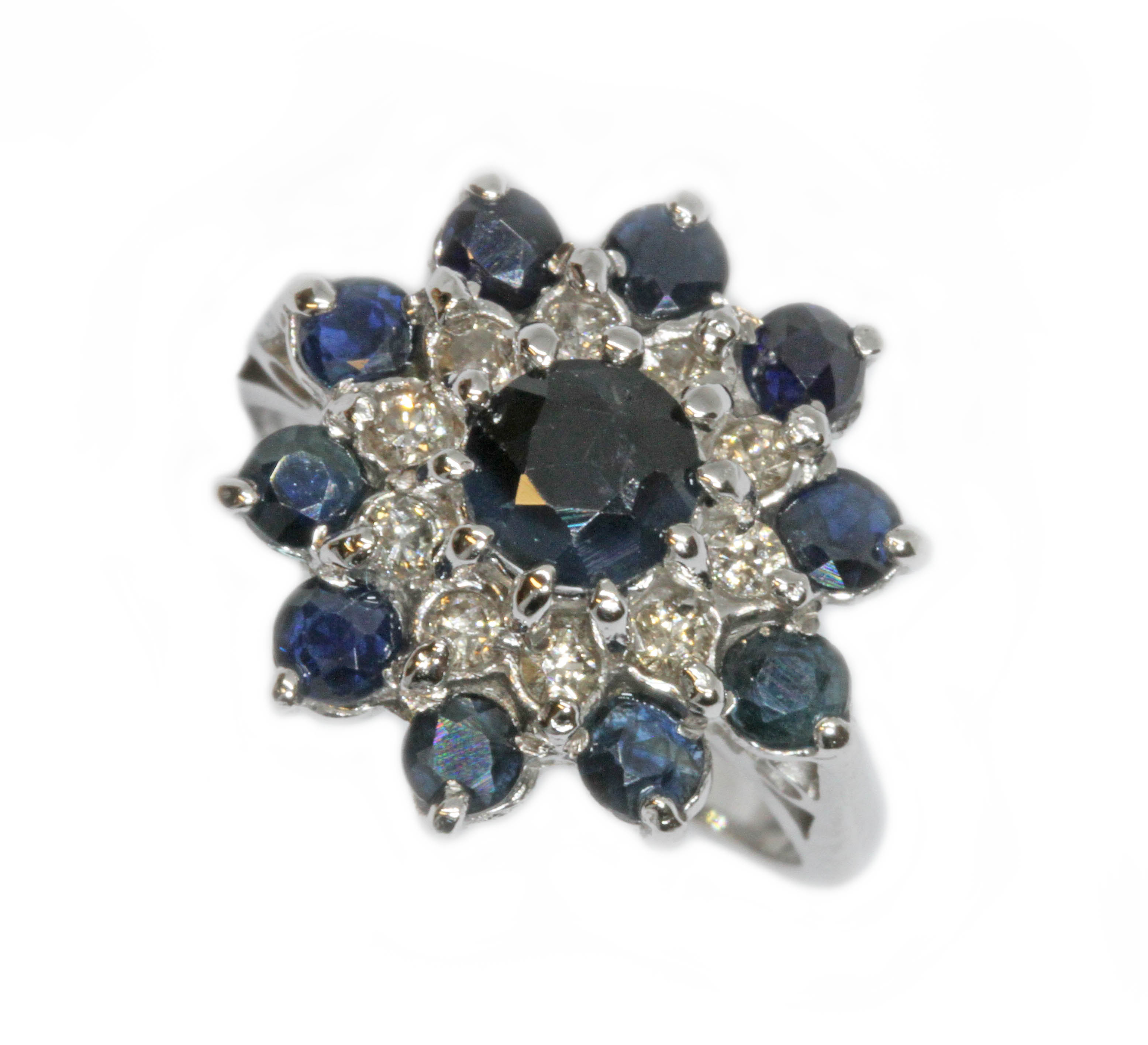 A diamond and sapphire cluster ring, the cluster measuring approximately 16mm in diameter, white