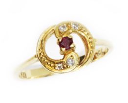 A diamond and ruby ring, marked '750', gross weight 2.6g, size L/M. Condition - general wear.