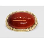 A hallmarked 9ct gold carnelian cabochon brooch, length 28mm, gross weight 5.7g. Condition - good,