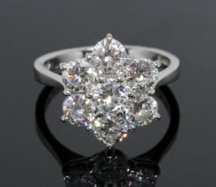 A seven stone diamond cluster ring, the daisy head cluster measuring approximately 15.12mm x 13.