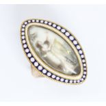 A Georgian navette ring, circa 1800, miniature portrait on ivory painted en grille, blue and white