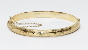 A hallmarked 9ct gold bangle, diameter approximately58mm, weight 8.5g Condition - good, minor wear
