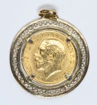 George V 1917 sovereign pieced round pendant mount, the bail marked '750', diameter 31mm, gross