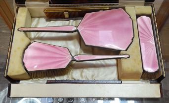 An early 20th century cased hallmarked silver and pink enamel dressing table set.