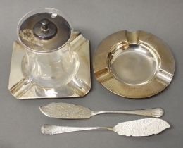 A mixed lot of hallmarked silver comprising two ashtrays, two knives and a silver topped preserve