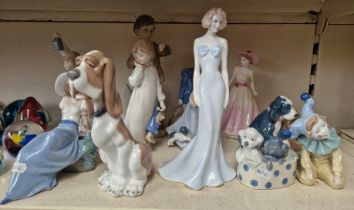 A group of 11 Nao porcelain figures.
