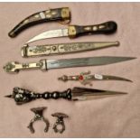 Four decorative daggers including Eastern Kukri style dagger.