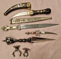 Four decorative daggers including Eastern Kukri style dagger.