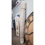 A large Chinese wool carpet, cream ground decorated with flowers. Width 250cm approx