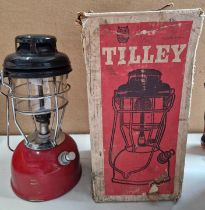 A red tilley lamp in original box.