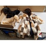 A vintage suitcase containing assorted furs to include rabbit coat & shoals etc.