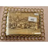 A brass wire photograph frame.