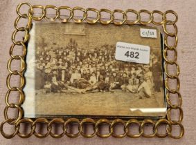 A brass wire photograph frame.