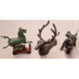 A cast iron doorstop modelled as a dog, cast iron bottle holder and a Chinese 'Flying Horse' metal