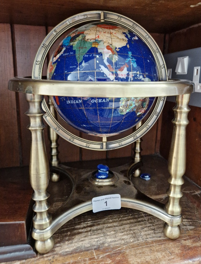 A gemstones globe on brass stand