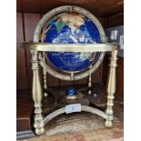 A gemstones globe on brass stand