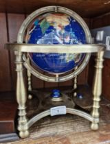 A gemstones globe on brass stand