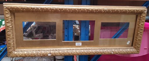 A 19th century glazed gilt frame, the wooden slip having three apertures, 85cm x 32.5cm (overall).