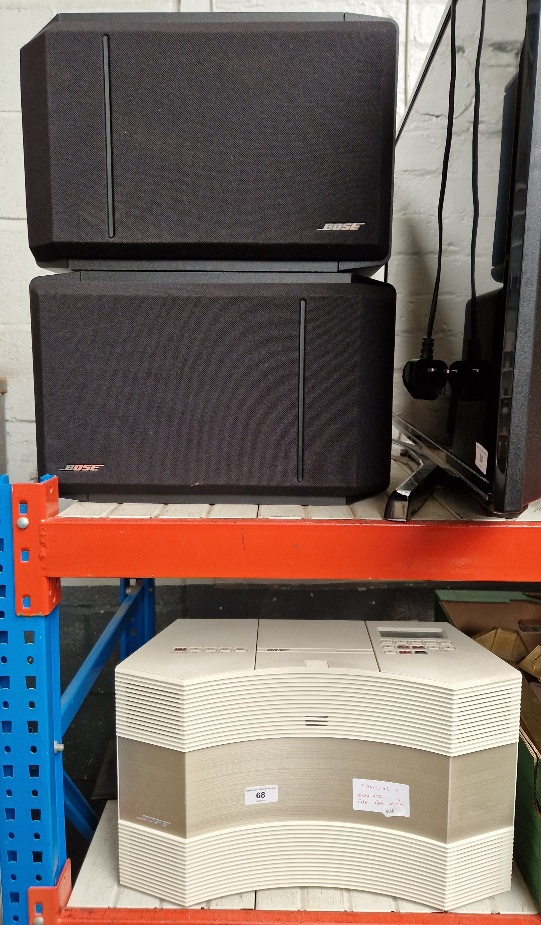 A Bose Acoustic Wave music system with remote and a pair of Bose 301 speakers.