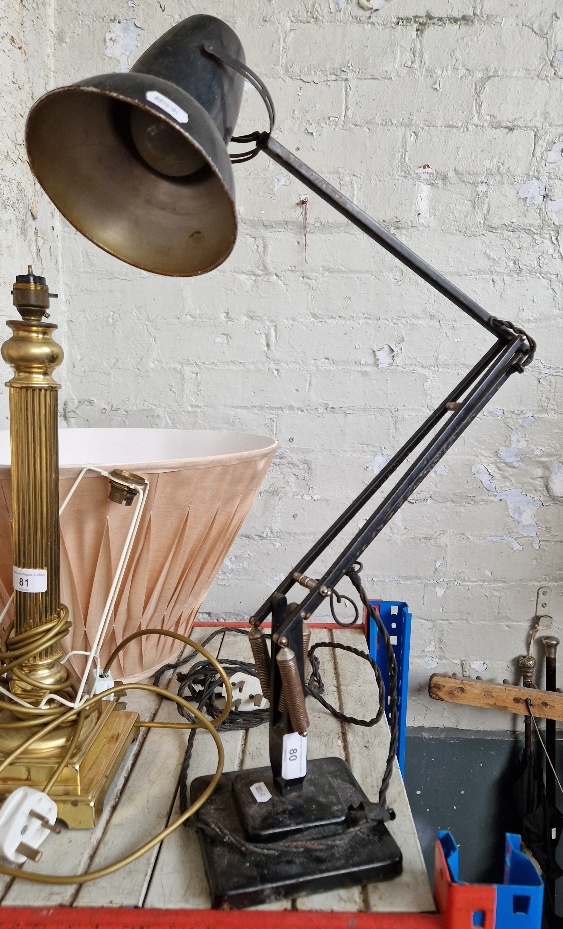 A black Herbert Terry & Sons Anglepoise lamp with two step base.