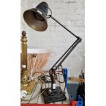 A black Herbert Terry & Sons Anglepoise lamp with two step base.