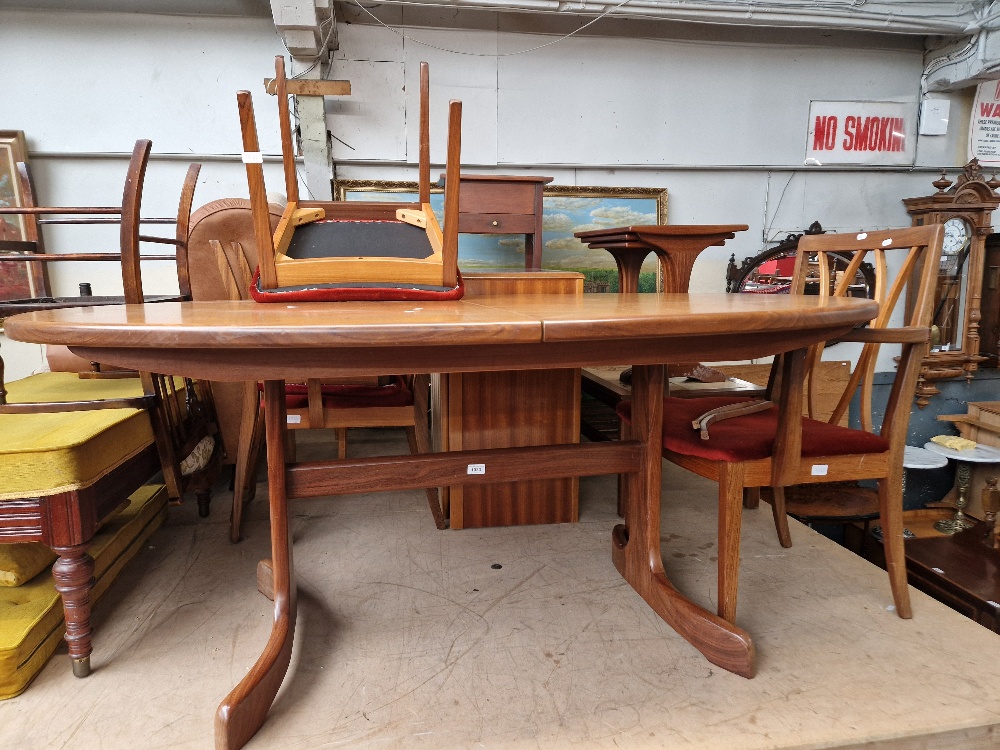 A mid 20th century G Plan teak extending dining table and four chairs.