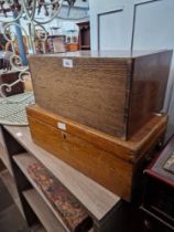 An oak cabinet fitted with drawers and an oak box with brass loop handles.