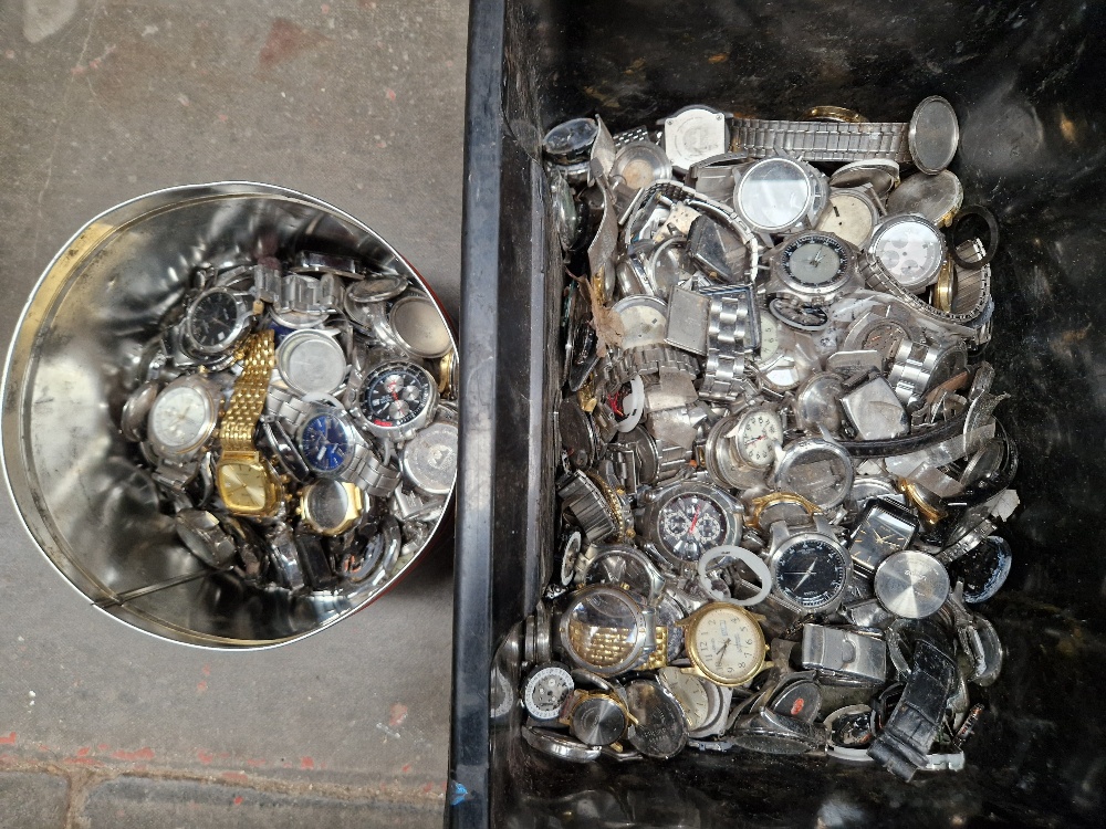 A box & a tin of assorted watches and watch parts