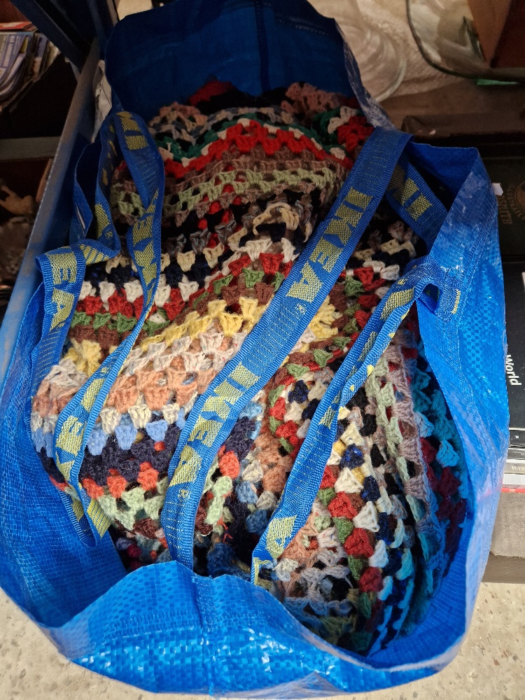 A bag of knitted woolen blankets.