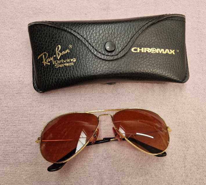 A pair of Ray-Ban Driving Series Chromax sun glasses.