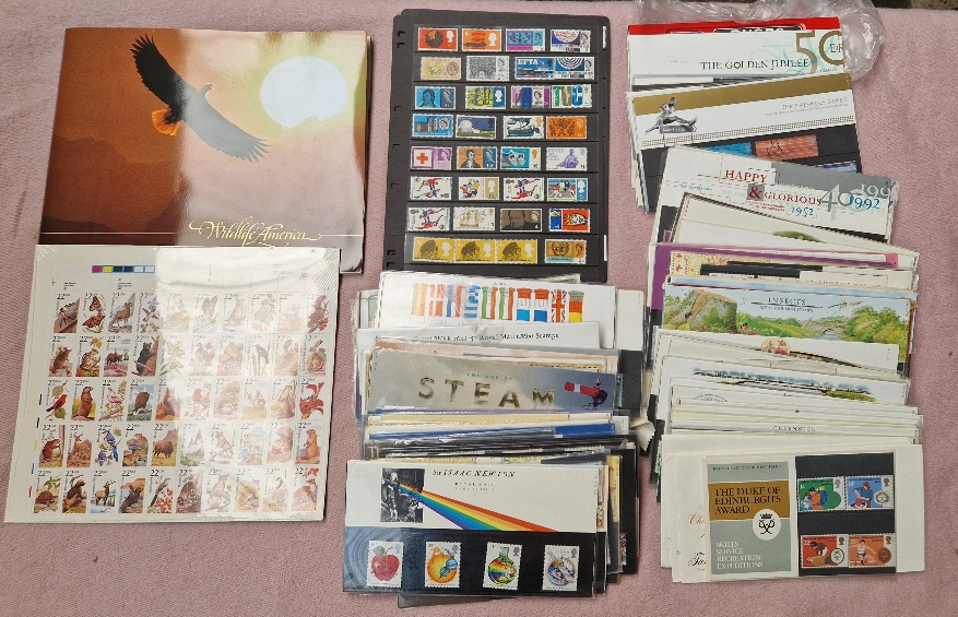 A box of mint stamps including Royal Mail Presentation Packs etc.