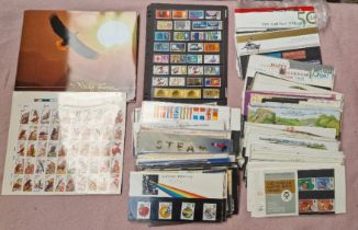 A box of mint stamps including Royal Mail Presentation Packs etc.