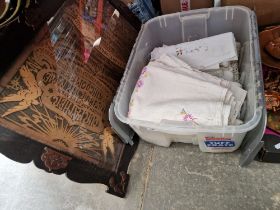 A box of assorted linen and a framed lord's prayer.