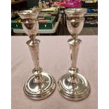 A pair of hallmarked silver candlesticks.