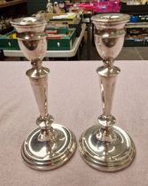 A pair of hallmarked silver candlesticks.