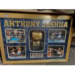 An Anthony Joshua signed glove and light up picture display.