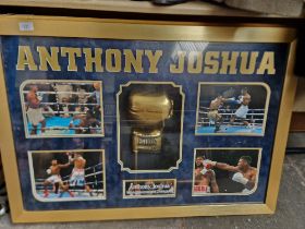 An Anthony Joshua signed glove and light up picture display.