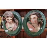 A pair of Victorian terracotta wall plaques featuring women's heads looking left and right