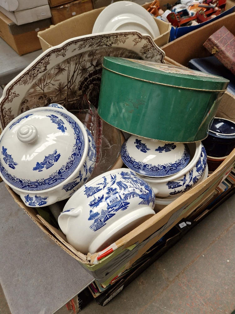 A box of assorted pottery, tins, Wedgwood platter, Churchill etc.