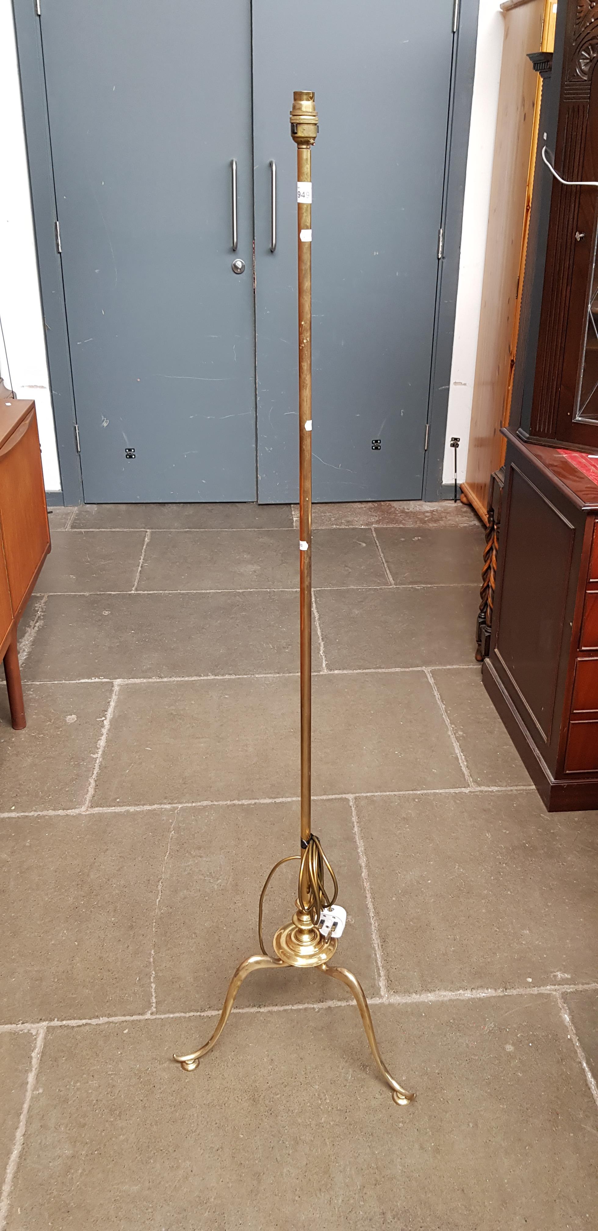 A vintage brass tripod standard lamp.