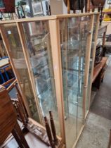 Three glass display cabinets with interior lights.
