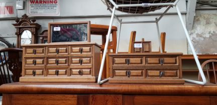 Two miniature chest of drawers.