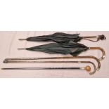 A bundle of 3 walking sticks and 2 umbrellas with silver tops/collars