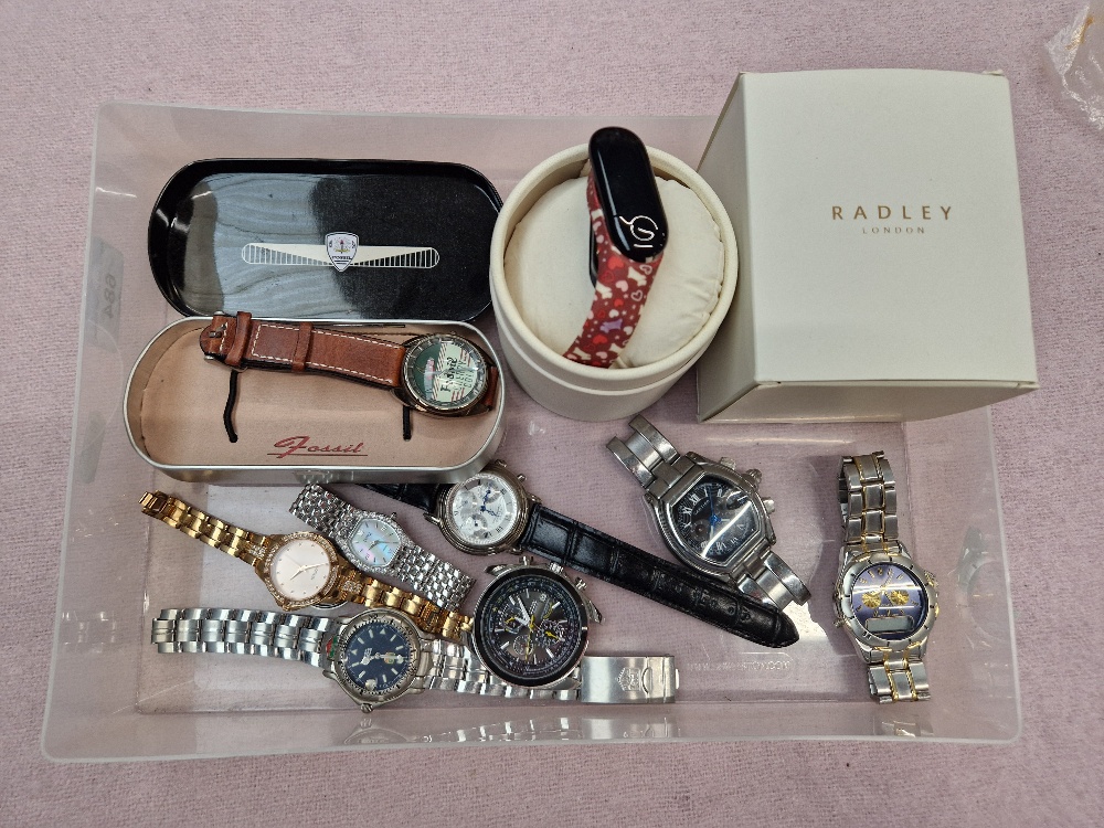 A box of ladies and gents watches including Fossil and Radley.