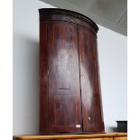 A George III inlaid mahogany corner cabinet.