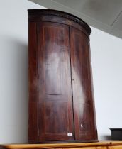 A George III inlaid mahogany corner cabinet.