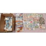 A mixed lot of collectors cards, banknotes and coins.