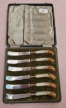 A cased set of six Royal Worcester pistol grip knives, hand painted and signed Stinton.